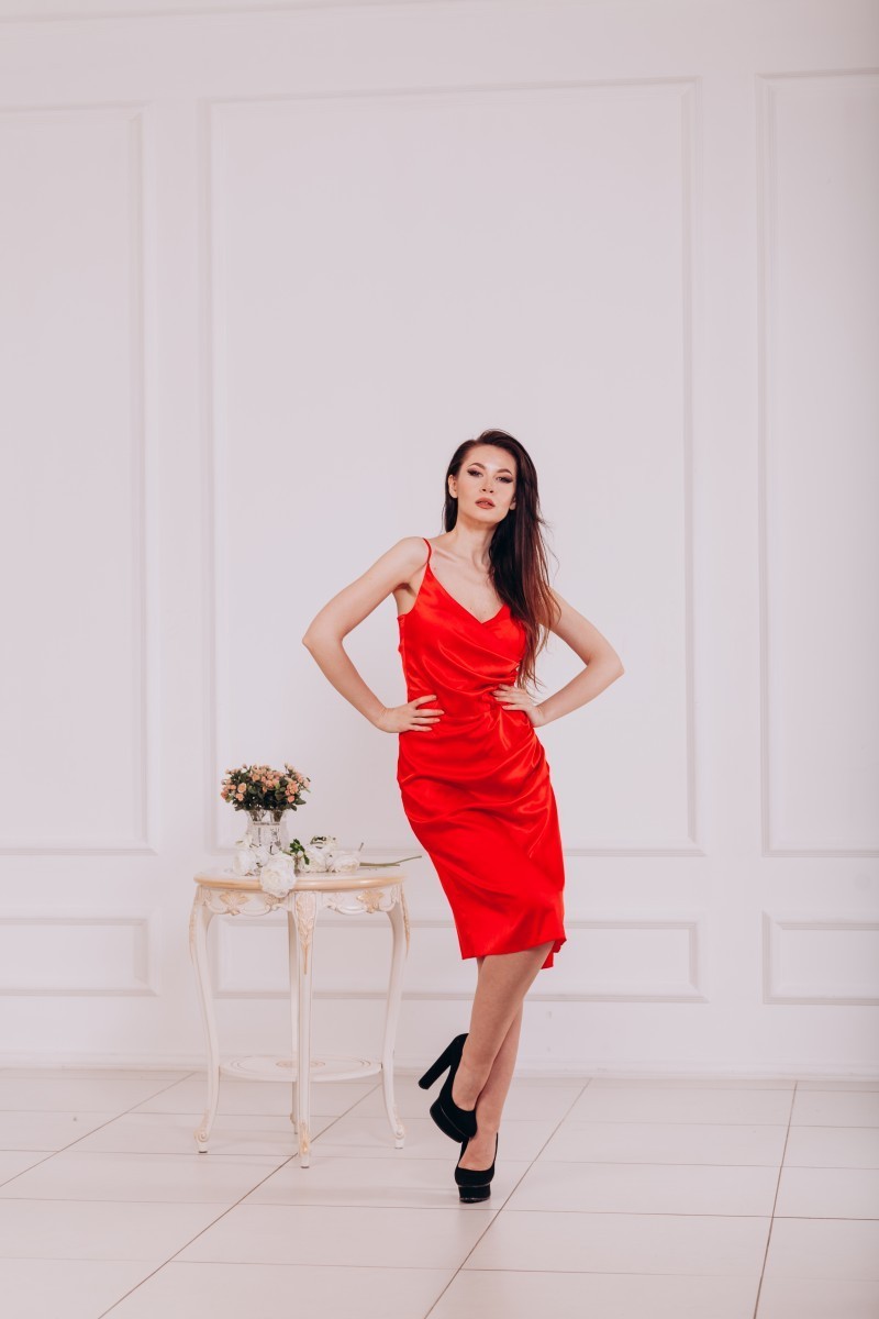 Red evening dress with a deep neckline and slit