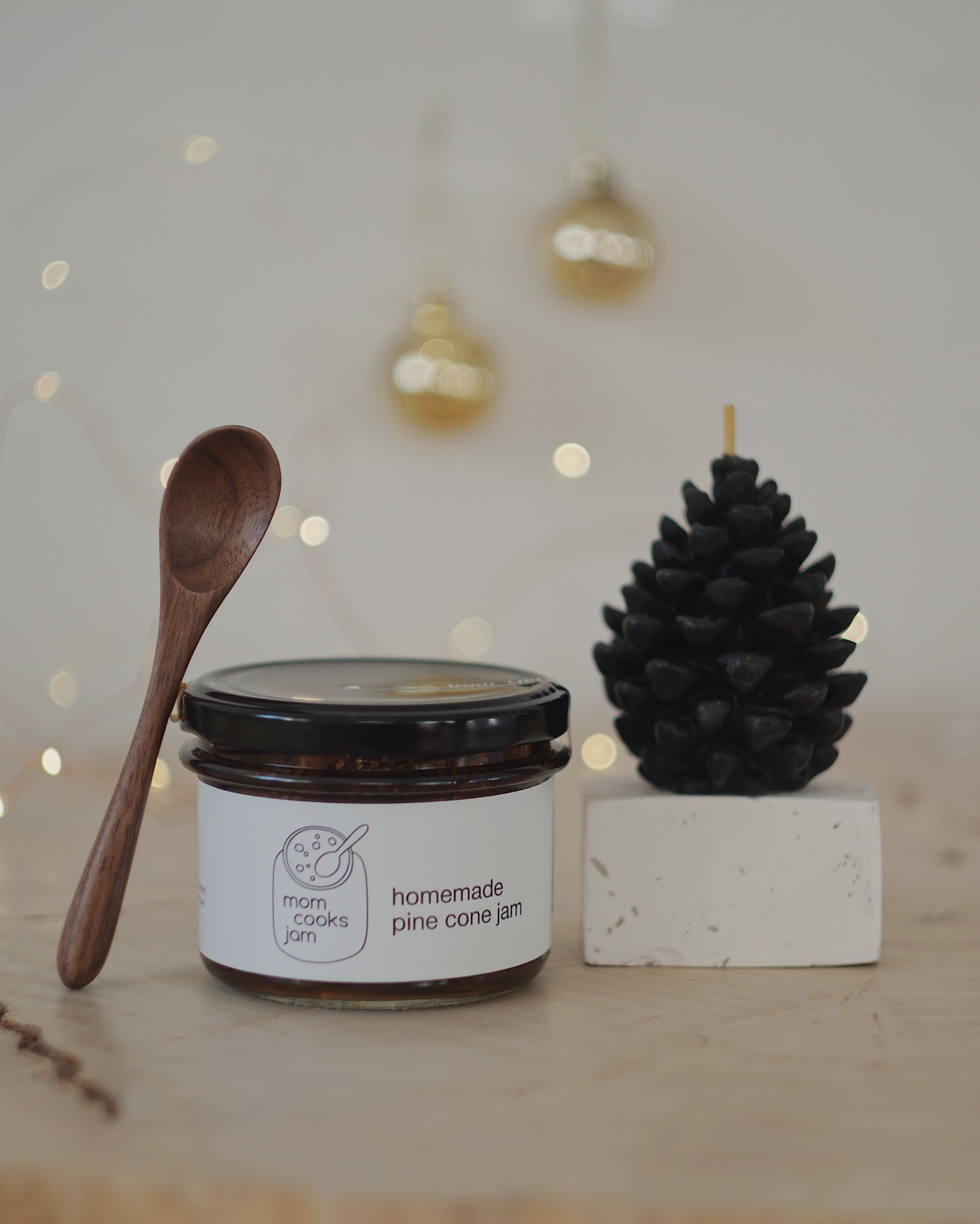 Christmas gift set with a pine cone jam, a wax candle and wooden spoon