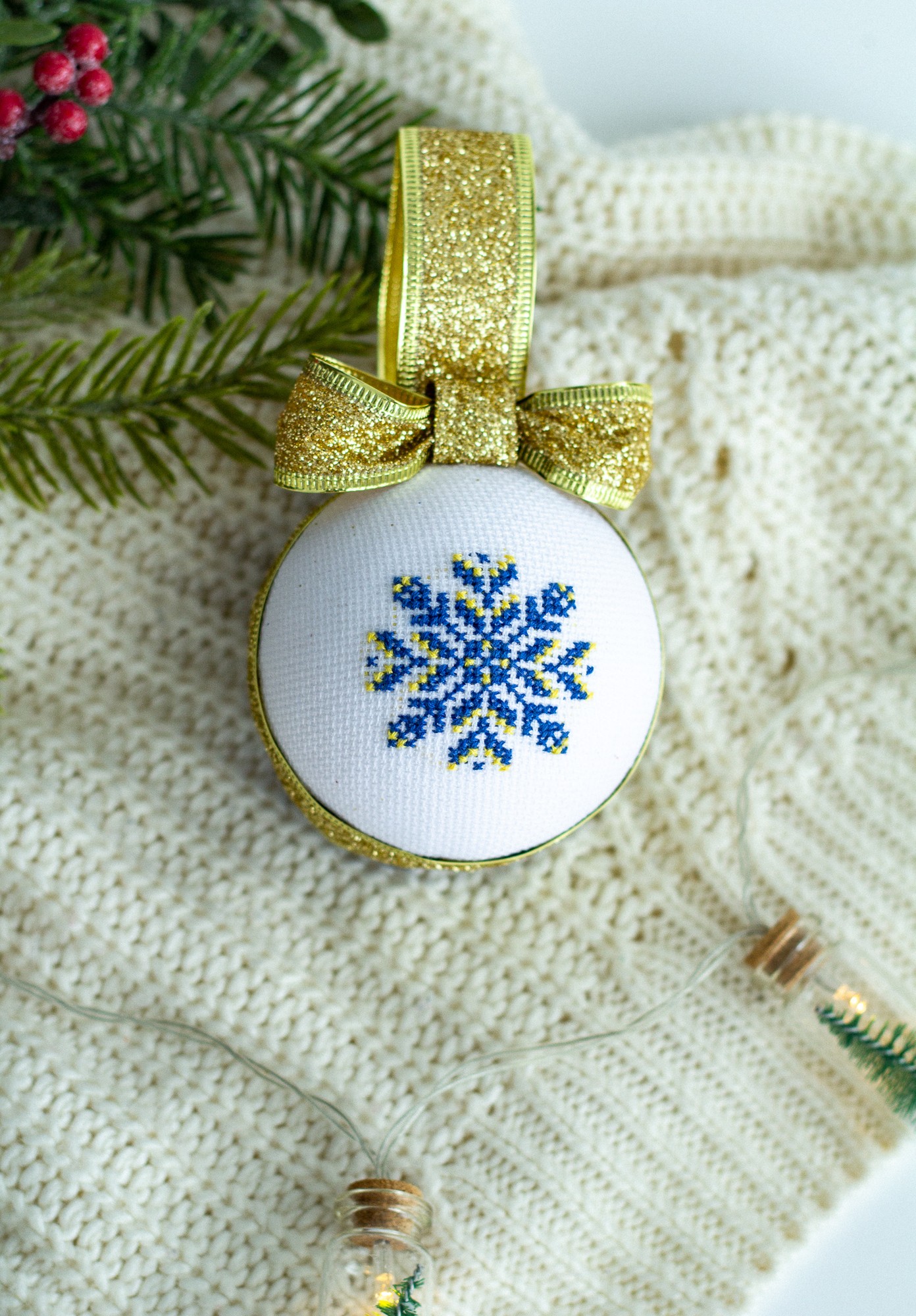 Christmas ball with Ukrainian ornament in blue-yellow color