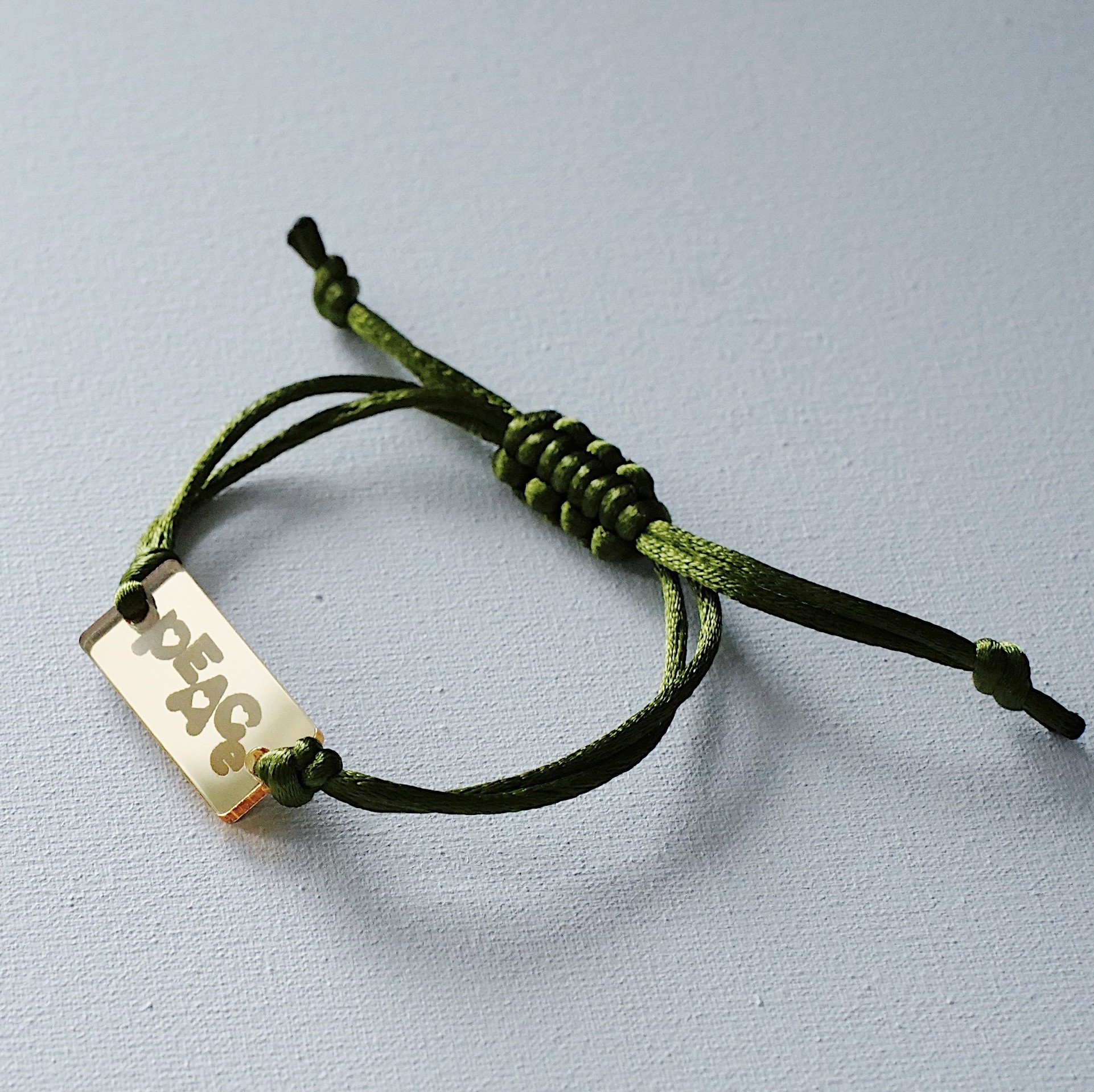 Bracelet "PEACE" by ARNO on a silk cord