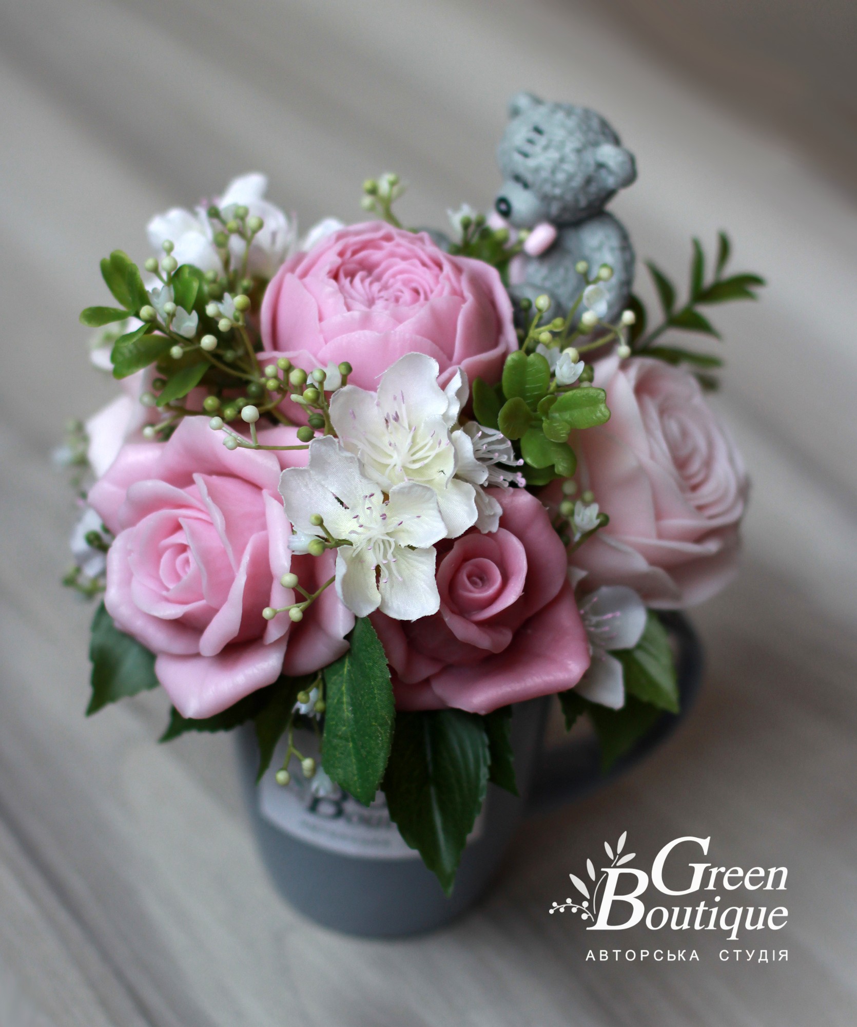 Small interior bouquet with a bear  in a ceramic cup