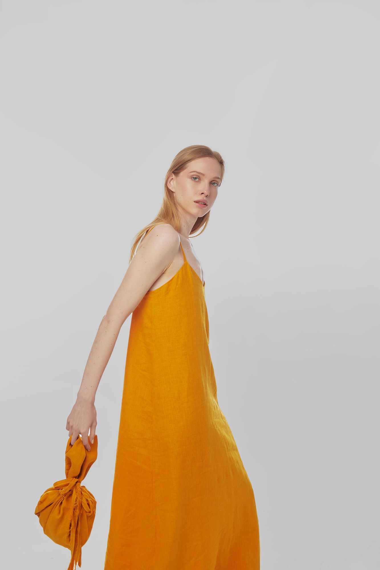 Linen sundress with long straps and raw back seam. Saffron color. Kvit Collection