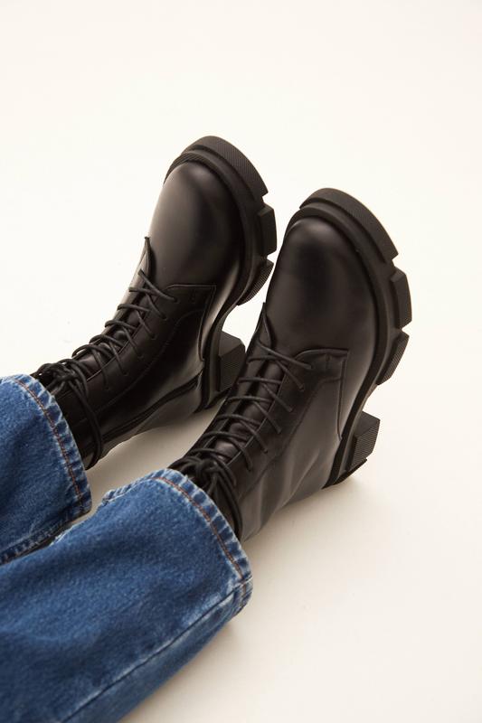 Black leather combat boots with ruble sole