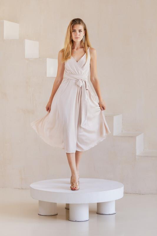 Elegant silk beige midi dress with shoulder straps with a slit